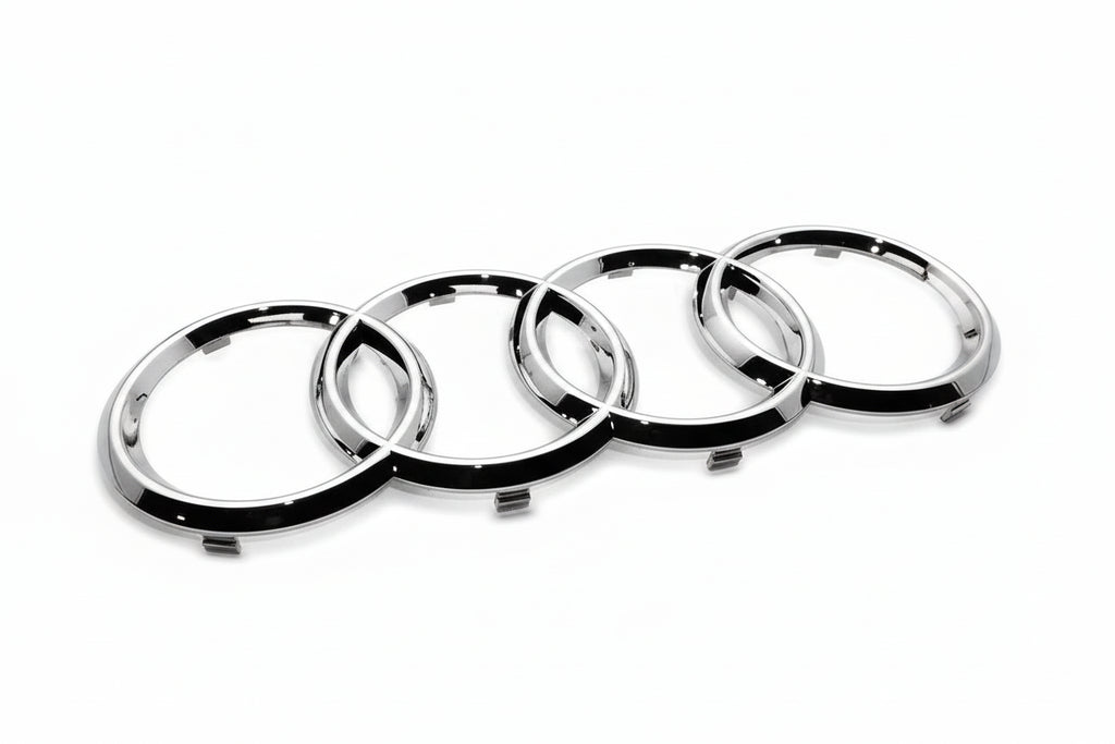 Audi Chrome car emblem with four interlocking rings on a white background
