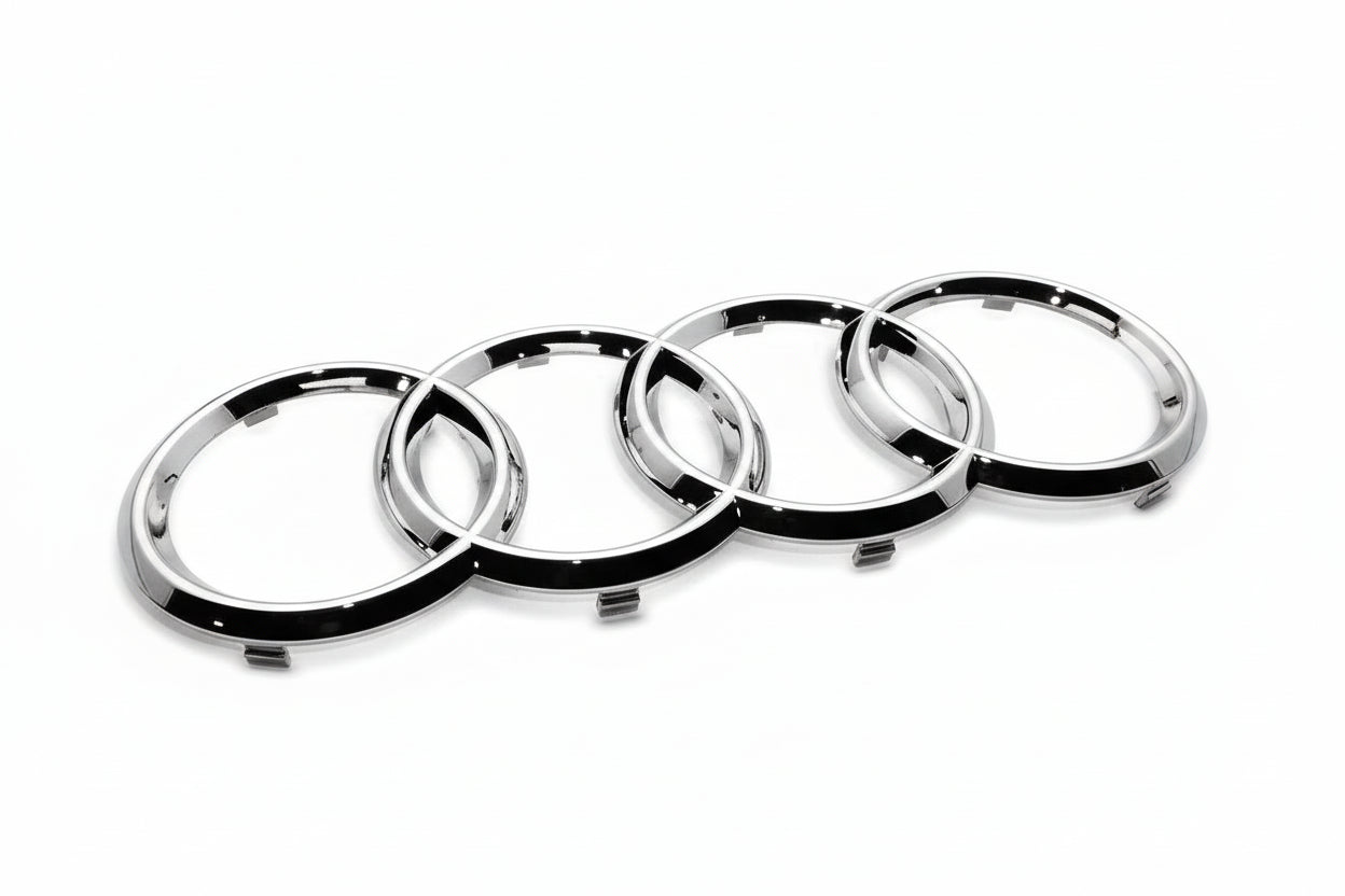 Audi Chrome car emblem with four interlocking rings on a white background